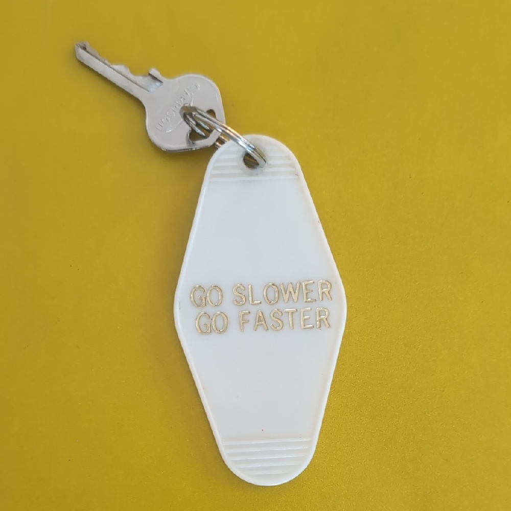 Drake Lyrics "Go Slower, Go Faster" Controlla White Retro Keychain In Gold Text